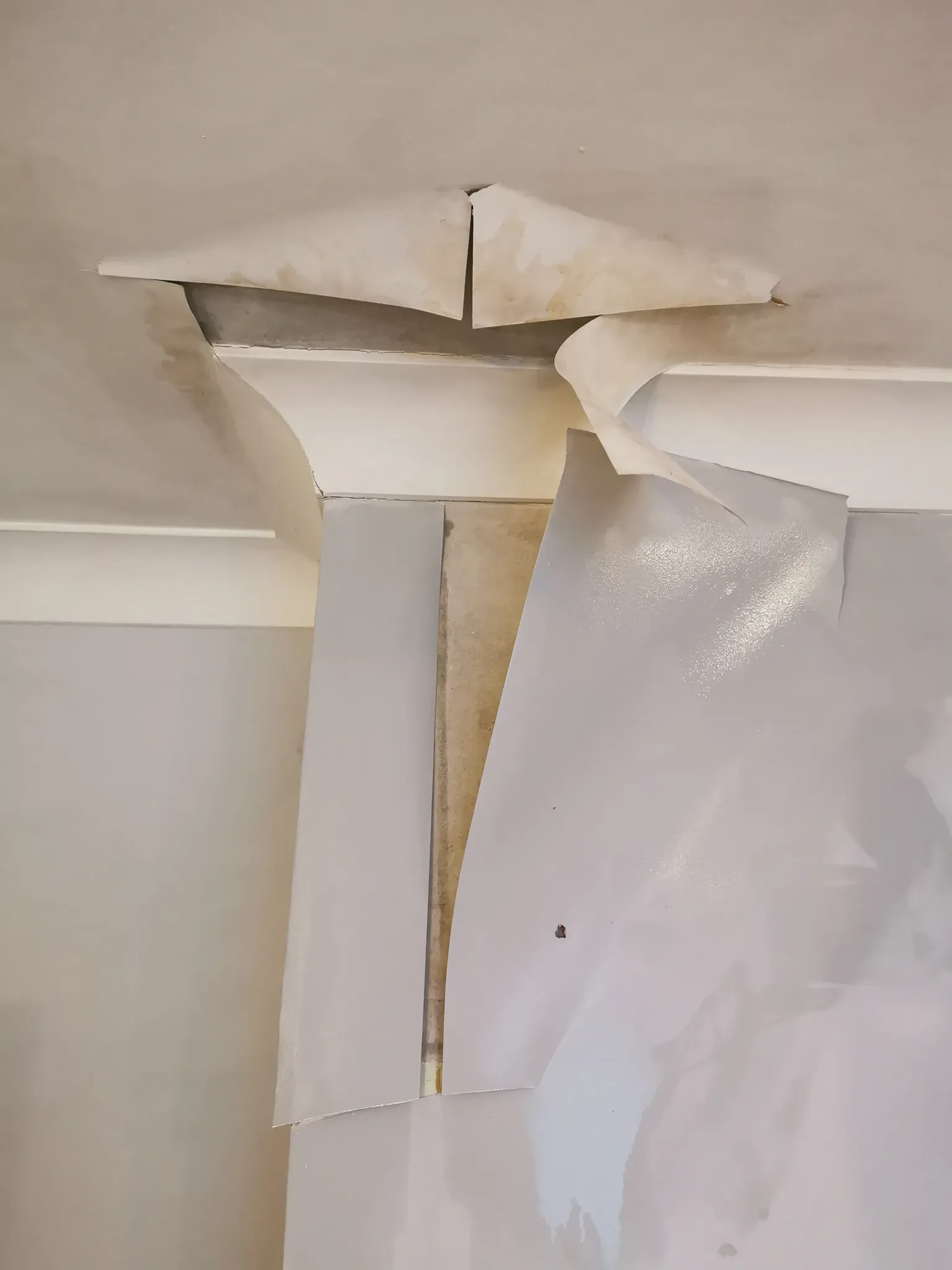 Damaged wallpaper before repair