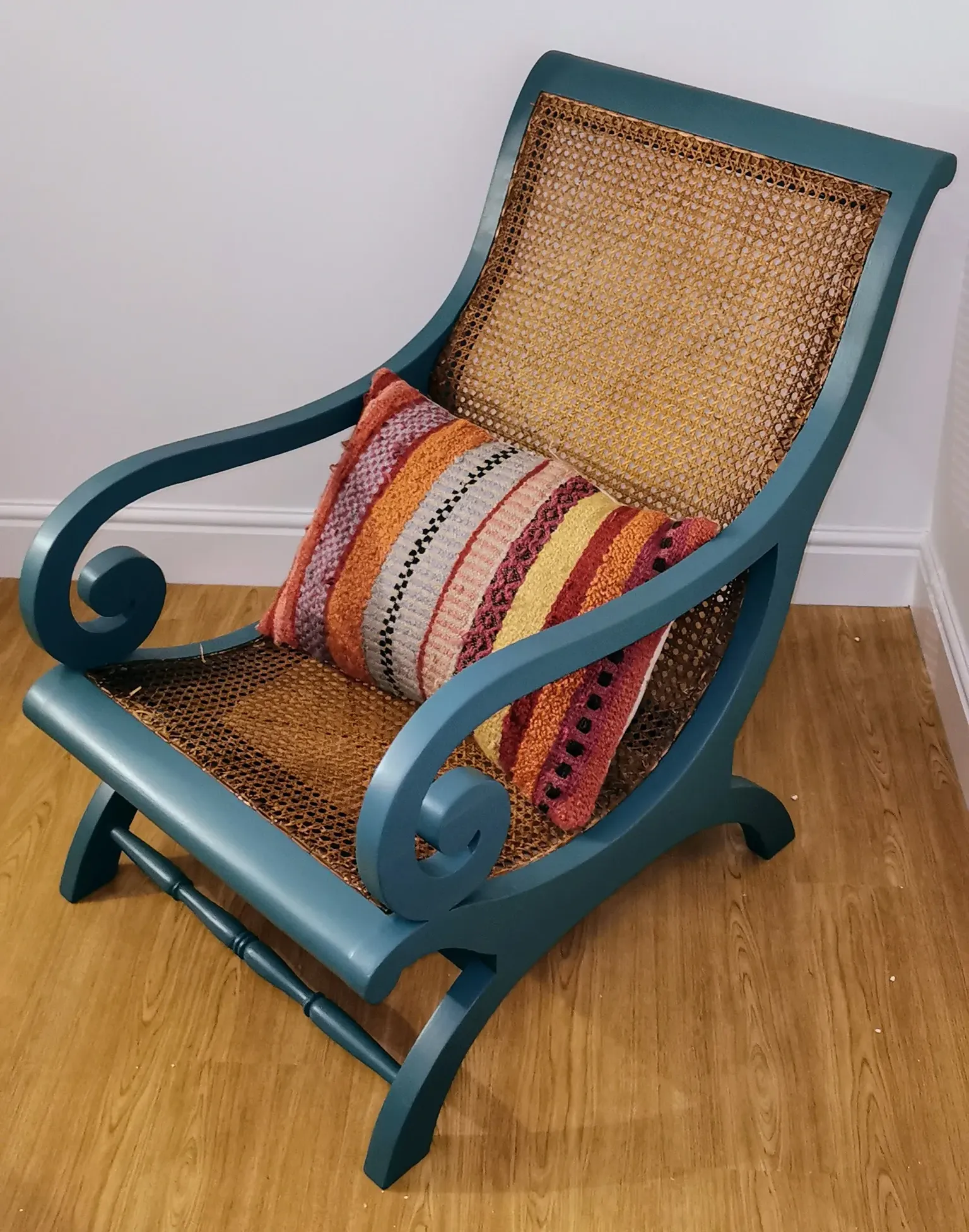 Newly painted wicker chair in a blue/green colour